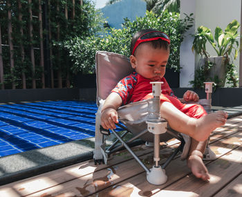 Portrait of cute girl sitting in swimming pool