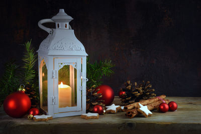 Lit candles on tree outside building