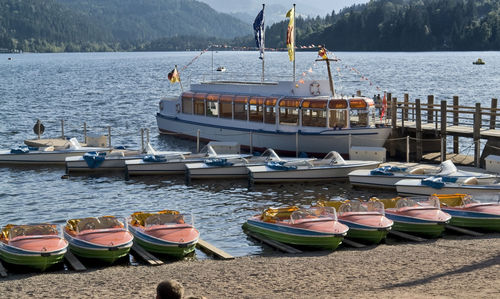 Sailboats moored on lake