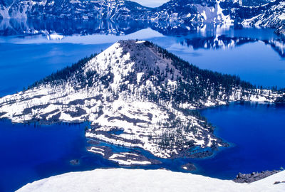 Scenic view of lake and snowcapped mountains during winter