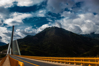 Panoramic view of bridge over mountains against sky