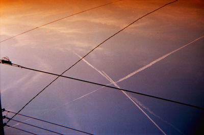 Low angle view of power lines against sky