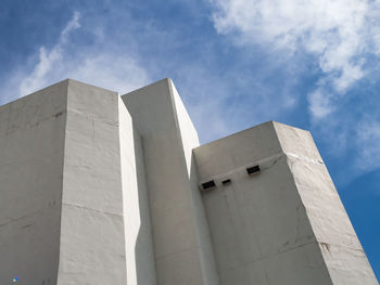 Low angle view of building against cloudy sky