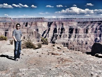 Full length portrait of man standing at grand canyon national park on sunny day