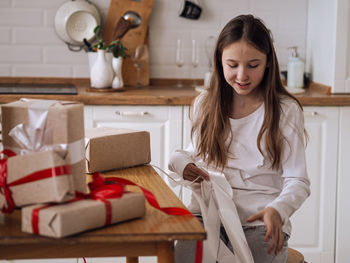 Portrait of young woman using mobile phone at home