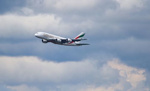 Low angle view of airplane flying in sky