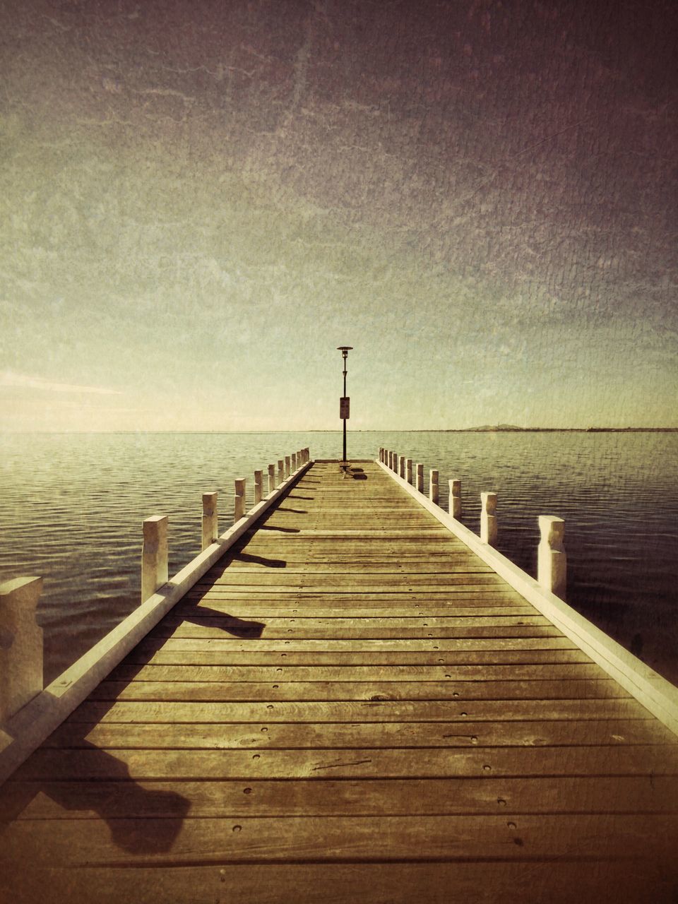 sea, water, pier, the way forward, tranquil scene, tranquility, horizon over water, jetty, scenics, wood - material, sky, nature, railing, beauty in nature, idyllic, boardwalk, copy space, calm, diminishing perspective, sunset