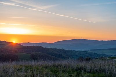 Scenic view of landscape against sky during sunset