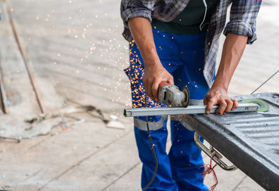 Low section of man working in workshop