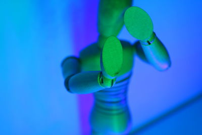 Close-up of wooden figurine against wall