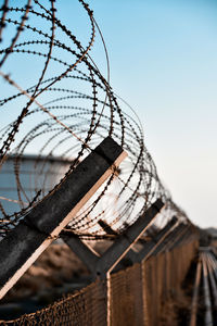 Close-up of razor wire against sky