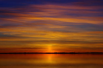 Scenic view of sea against orange sky