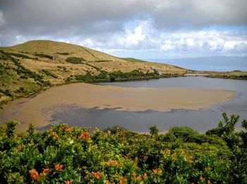 Scenic view of sea against cloudy sky