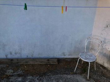 Empty chair against wall