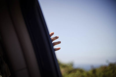 Close-up of hand against clear sky