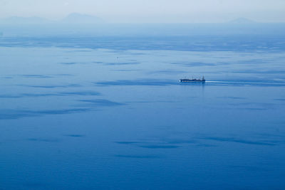 Maritime coast of the tyrrhenian sea with merchant ship, travel reportage in southern of calabria