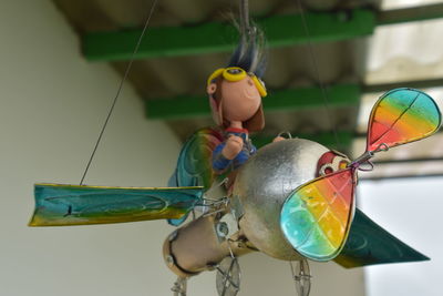 Low angle view of helicopter figurine hanging from ceiling