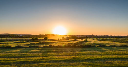 Scenic view of field against sky during sunset