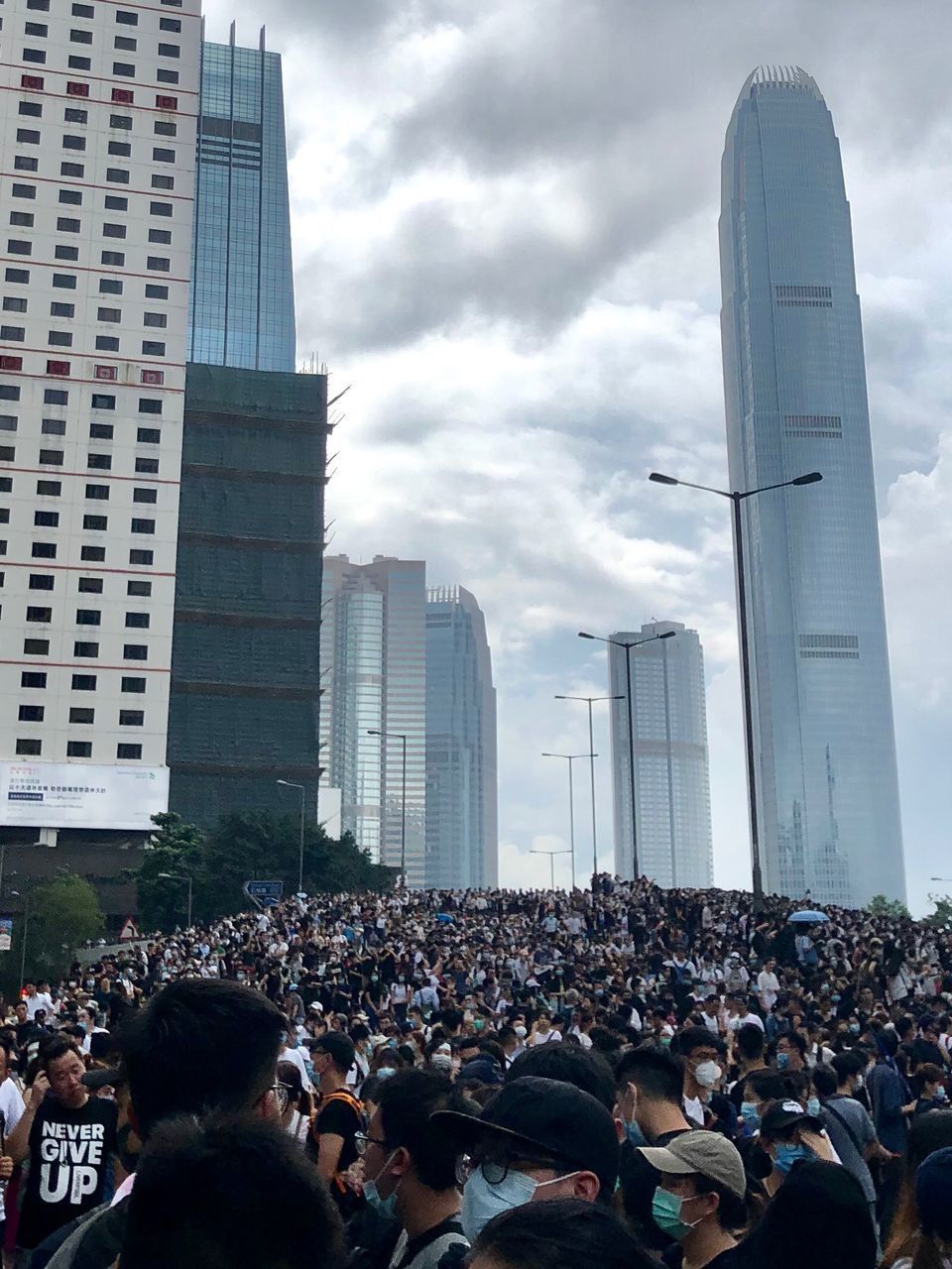 GROUP OF PEOPLE ON CITY BUILDINGS AGAINST SKY