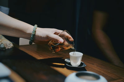 Woman holding coffee cup on table