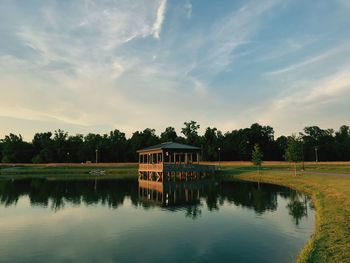 Scenic view of lake by building against sky