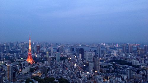 High angle view of illuminated city buildings against sky