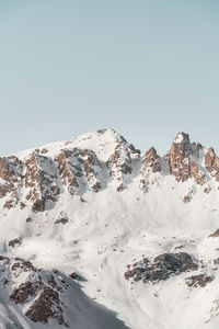 Scenic view of snowcapped mountains against clear sky