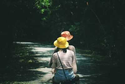 Rear view of man standing in forest