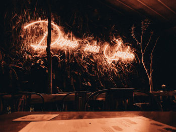 Illuminated light painting on table at night