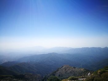 Scenic view of mountains against clear blue sky