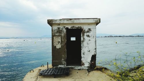 Built structure on beach against sky