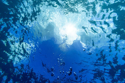 Low angle view of people swimming in sea