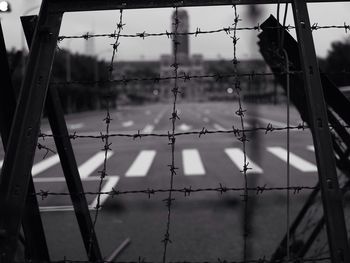 Chainlink fence against cloudy sky