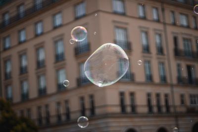 Low angle view of bubbles against building