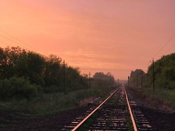 View of railroad tracks against sky during sunset