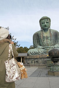 Statue of buddha against sky