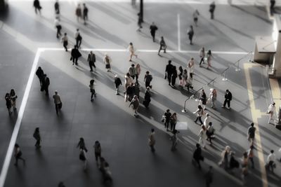 Tilt-shift image of people walking in airport building