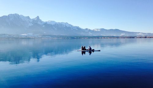 Calm lake with mountains in background