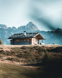 Built structure on countryside landscape against sky