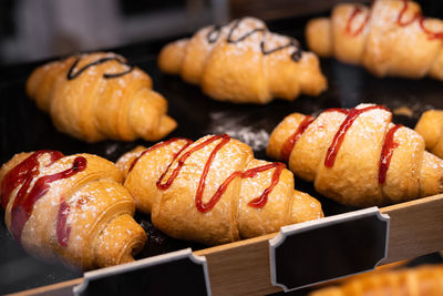 Delicious croissants with filling in the shop window