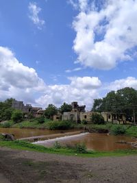 Old building on field against sky