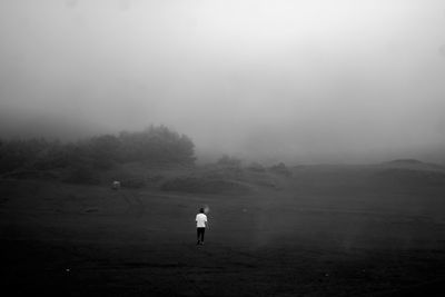 Rear view of man walking on mountain