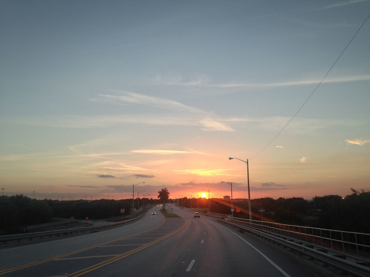 HIGHWAY BY ROAD AGAINST SKY DURING SUNSET