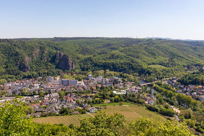 Scenic view of agricultural field by buildings against sky