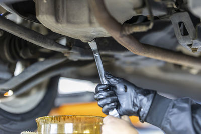 Close-up of man repairing car