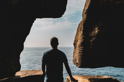 Rear view of man looking at sea