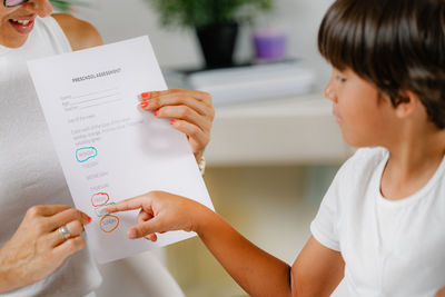 Preschooler screening test. boy pointing and answering questions.