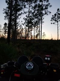 View of camera on field against sky during sunset