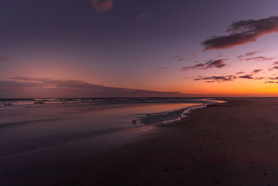 Scenic view of beach against sky during sunset