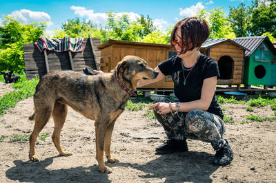 Dog at the shelter. animal shelter volunteer feeding the dogs.